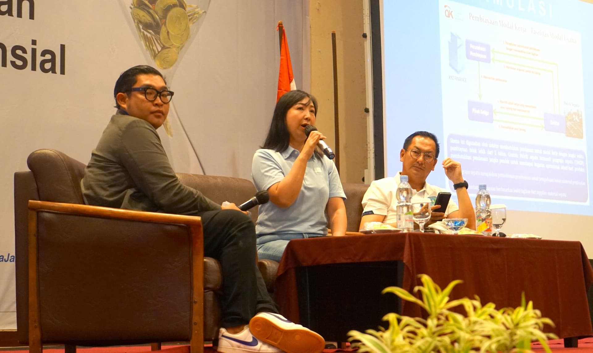 Priscilla Angeline, Finance Head of BFI Finance, presents as speaker, accompanied by Isyak Meirobie, Belitung Vice Regent (far right)